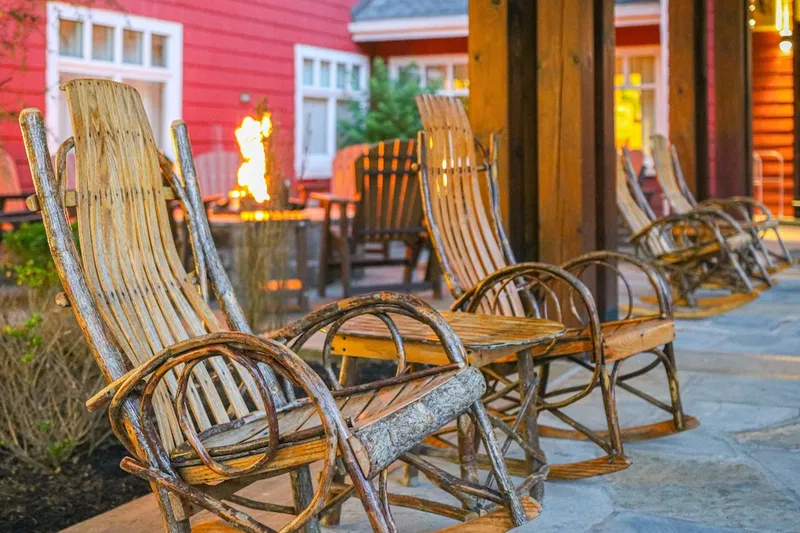 porch rockers with fire pit in background