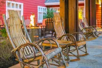 porch rockers with fire pit in background