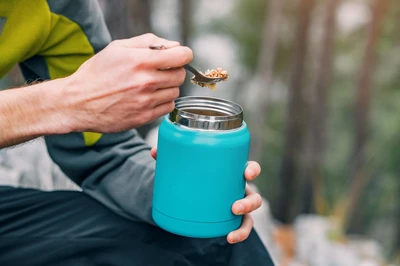 hiker eating food with spoon