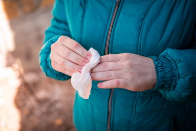 hiker wiping hands