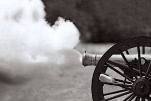 A cannon firing during a Civil War battle reenactment.