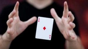 A magician suspending a playing card in the air.