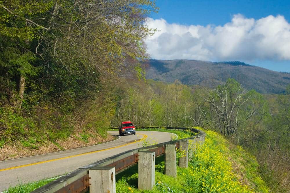 A car driving on Newfound Gap Road in the Smoky Mountains.