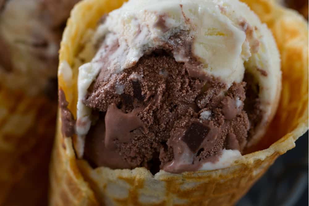 Chocolate and vanilla ice cream in a tasty waffle cone.